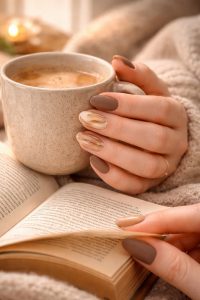 読書を楽しむ指先とマットブラウンのネイル